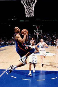 John Starks elevates for a reverse dunk in Dallas.